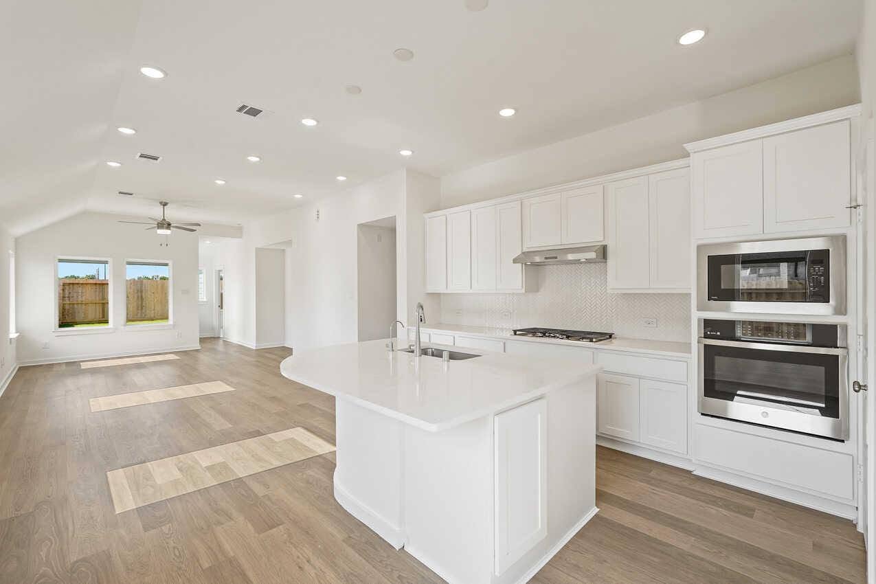 Contemporary interior with white kitchen and open living area